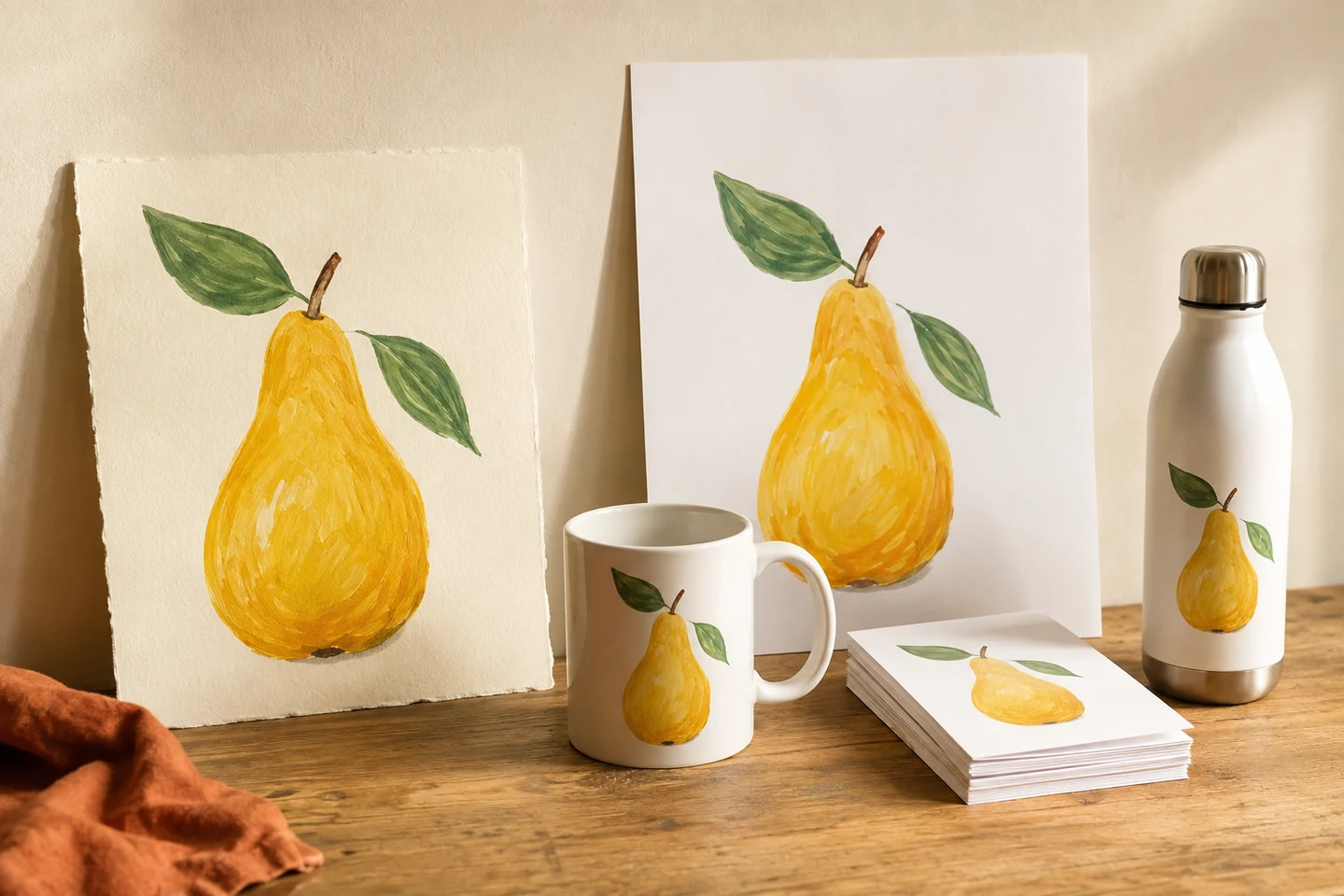 A painting of a pear shown as a print, on a mug, on a water bottle and on a stack of small cards, on a wooden shelf