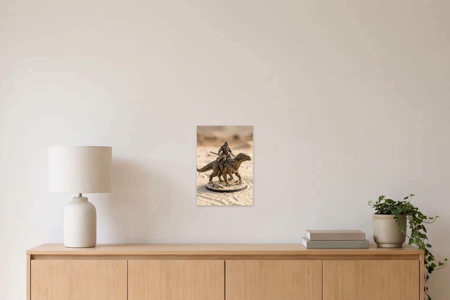 An A3 art print, 11.7 × 16.5 in, on a wall above a sideboard with a table lamp, shown to scale with example artwork